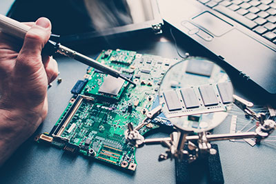 An engineer servicing a laptop Buried Via PCB