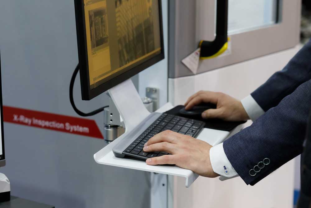 An operator checking the X-ray of a printed circuit board